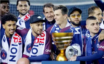  ??  ?? Neymar (front, second left) and team mates celebrate with the Coupe de la Ligue trophy. — Reuters photo