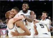  ?? FRANK FRANKLIN II — THE ASSOCIATED PRESS ?? Villanova’s Donte DiVincenzo, left, Mikal Bridges, Eric Paschall (4) and teammates, rear, celebrate after an NCAA college basketball game against Providence in the Big East men’s tournament final Saturday, March 10, 2018, in New York.