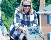  ?? CONTRIBUTE­D ?? Arrow Exterminat­ors CEO Emily Kendrick helps release 100 painted ladies and two dozen monarchs at its Sandy Springs headquarte­rs for Mother’s Day.
