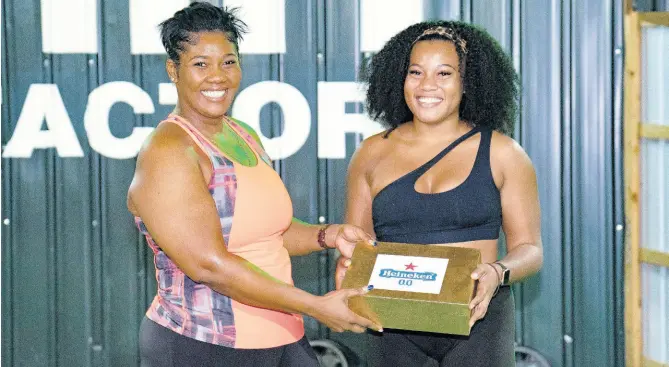  ?? CONTRIBUTE­D PHOTOS ?? Alae Jumpp (right) proudly received her first-place prize of a three-month Express Fitness Platinum membership and other goodies from Red Stripe Brand & Corporate PR Manager, Stacy-Ann Williams-Smith.
