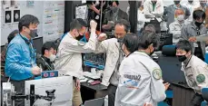  ?? JAXA ?? Workers celebrate the success of a maneuver Saturday at JAXA’s Sagamihara campus, near Tokyo. The asteroid samples contained in the capsule may explain the origin of life.