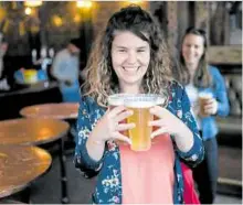  ?? —AFP ?? THIRST IS OVER Customers leave with pints of beer from a pub in east London on June 27. The scene is also playing out in Ireland, which reopened watering holes on June 29.