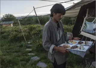  ??  ?? A dinner using local foods, this time including yak meat, is brought to guests at Norden Camp.