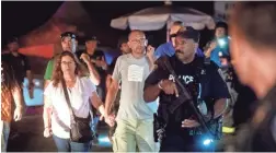  ?? NOAH BERGER/AP ?? Police officers escort people from Christmas Hill Park following a deadly shooting at the Gilroy Garlic Festival in Gilroy, Calif., on Sunday.