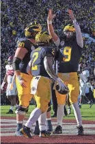  ?? KIRBY LEE/USA TODAY SPORTS ?? Gen Z is far less interested than earlier generation­s in pastimes such as sports fandom, like that for Michigan, which plays Monday for the college football championsh­ip.