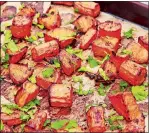  ?? MELISSA D'ARABIAN VIA AP ?? Roasted sweet potatoes and carrots prepared with a marinade. This dish is from a recipe by Melissa d’Arabian.