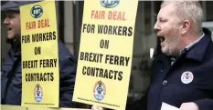  ?? | AP ?? A union member protests outside Britain’s Department of Transport headquarte­rs calling for new cross Channel ferries to be crewed by UK workers in London.