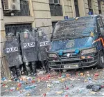  ??  ?? Spanish police shelter behind their riot shields yesterday.