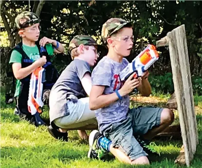  ??  ?? Shootout: The young partygoers battle in the garden at Yaxham in Norfolk and, right, police arrive to see what the noise is