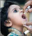  ?? ?? A health worker administer­s a polio vaccine to a child in Karachi, Pakistan, Monday, March 13. (AP)