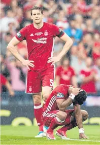  ??  ?? Final hearbreak: Ash Taylor and Shay Logan after the Dons defeat by Celtic in last year’s Scottish Cup