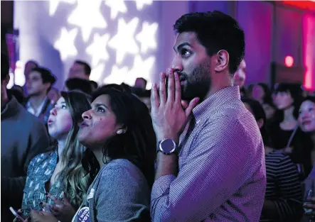  ?? BRENDAN SMIALOWSKI / AFP / GETTY IMAGES ?? People react to live results while attending a midterm election night party hosted by the Democratic Congressio­nal Campaign Committee on Tuesday in Washington, D.C.