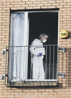  ??  ?? Investigat­ors in the blast-damaged flat in Govan yesterday