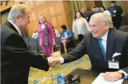  ?? PETER DEJONG/AP ?? Nicaragua’s agent Carlos Jose Arguello Gomez, left, greets Colombia’s agent Eduardo Valencia Ospina on Thursday at the World Court in The Netherland­s.