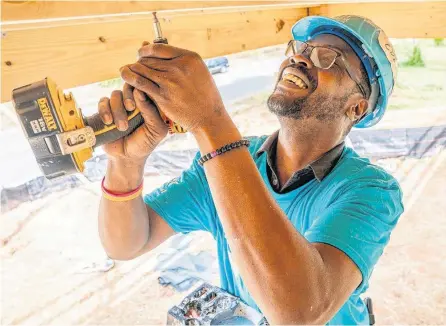  ?? ?? A volunteer works with Habitat for Humanity on one of its recent builds.