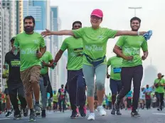  ?? Ahmed Ramzan/Gulf News ?? Social runners and families enjoyed the fun-filled 5km route, which passed by Dubai Mall, Dubai Opera and Burj Khalifa.