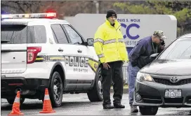  ?? TINA MACINTYRE-YEE / DEMOCRAT & CHRONICLE ?? Police officers probe a bomb threat Tuesday outside the Louis S. Wolk Jewish Community Center of Greater Rochester in Brighton, N.Y.