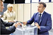  ?? ?? President Macron votes in the parliament­ary elections