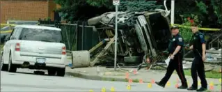  ?? CATHIE COWARD, THE HAMILTON SPECTATOR ?? Police investigat­e a crash outside the St. Nicholas Serbian Orthodox Church on Barton and Division streets.