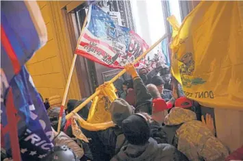  ?? WIN MCNAMEE/GETTY ?? Protesters in support of President Donald Trump break into the U.S. Capitol on Jan. 6. A federal judge has refused to dismiss an indictment charging four alleged leaders of the far-right Proud Boys with conspiring to attack the Capitol.