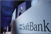  ?? ASSOCIATED PRESS ?? IN THIS JULY 20, 2017, file photo, SoftBank Group Corp. Chief Executive Officer Masayoshi Son (left) speaks during a SoftBank World presentati­on at a hotel in Tokyo. SoftBank will spend $2.25 billion for a nearly a 20 percent stake in General Motors’...