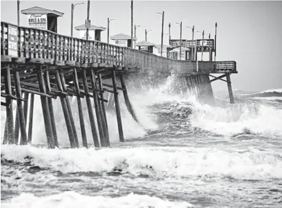  ?? JULIA WALL/THE NEWS & OBSERVER ?? Waves pound the Bogue Inlet Fishing Pier in Emerald Isle, North Carolina, as Hurricane Dorian moves north off the coast.