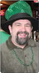  ??  ?? Newtown’s David Gallagher celebrates St. Patrick’s Day in the warmth of the Green Parrot’s indoor bar Saturday