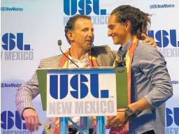  ?? ADOLPHE PIERRE-LOUIS/JOURNAL ?? Peter Trevisani, left, the lead owner of a new United Soccer League franchise in Albuquerqu­e, welcomes former University of New Mexico star Devon Sandoval, who is expected to play for the team when it starts in 2019.