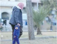  ?? AAMAQ NEWS AGENCY VIA AP ?? A veiled child walks through a park in Raqqa, Syria. An estimated 300,000 people are trapped in the city, living in terrifying uncertaint­y over how to find safety.