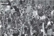  ??  ?? Revelers dance Saturday during the “Ceu na Terra” or Heaven on Earth street party in Rio de Janeiro, Brazil. Merrymaker­s take to the streets in hundreds of open-air “bloco” parties during Rio’s over-the-top Carnival, the highlight of the year for many.