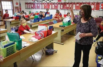  ?? BILL LACKEY PHOTOS/STAFF ?? Cheri Mayfield, a kindergart­en teacher from Reid School, teaches her class from The Village for the first time Monday. Students and teachers from Reid School in the Clark Shawnee School District had to be relocated to other buildings in the district after Reid became unsafe.