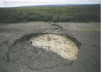  ?? ASSOCIATED PRESS FILE PHOTO ?? A section of highway in Canada’s Northwest Territorie­s collapsed because warming temperatur­es caused the permafrost below it to thaw. Scientists revealed the melting permafrost could also release mercury.