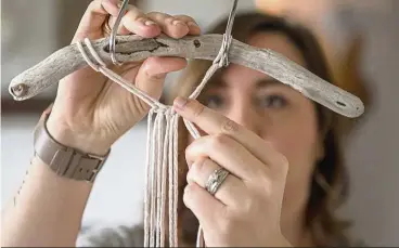  ??  ?? Morrison starts a small macrame wall hanging.