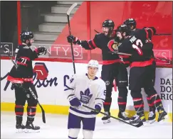  ?? CP PHOTO SEAN KILPATRICK ?? Ottawa Senators left wing Austin Watson (16), middle back, celebrates a goal with teammates as Toronto Maple Leafs left wing Alexander Barabanov (94) skates away during second period NHL action in Ottawa, Friday.