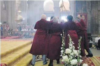  ??  ?? Men pull on ropes to swing the massive incense burner called a “botafumeir­o” at a pilgrims’ Mass inside the cathedral of Santiago de Compostela, Spain.