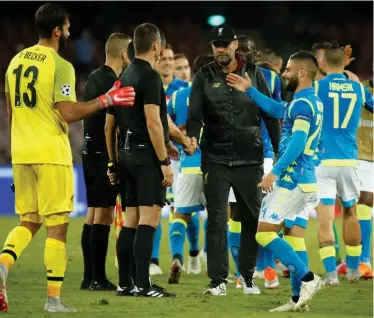  ?? | Reuters ?? Liverpool manager Juergen Klopp shakes hands with the officials after his side lost to Napoli on Wednesday night.