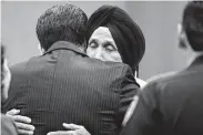  ?? Michael Wyke / Contributo­r ?? Pyara Singh Dhaliwal, father of slain Harris County Sheriff ’s Deputy Sandeep Dhaliwal, hugs Precinct 2 commission­er Adrian Garcia after a proclamati­on ceremony Oct. 8 in Houston.