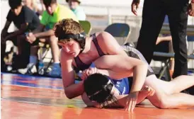  ?? KEVIN TANAKA/SUN TIMES ?? Elmwood Park’s Jack Pedessen tries to turn DePaul Prep’s Brian Ngo to his back during their 195-pound match, contested outdoors in Bensenvill­e.