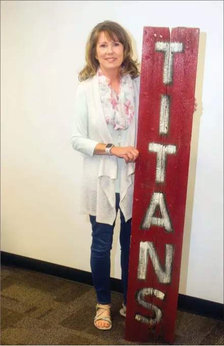  ?? MARK BUFFALO/THREE RIVERS EDITION ?? Marye Jane Brockinton holds a Titans sign at the Jacksonvil­le North Pulaski School District Central Office. Brockinton, who worked in education for 16 years, retired at the end of the 2018-19 school year. She was an assistant principal at Jacksonvil­le High School for the past three years.