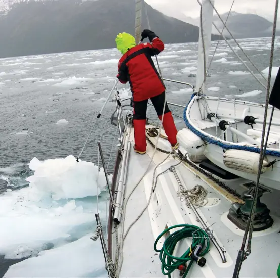  ??  ?? Alisa and the boys are on a mission: set a pot for centolla, the king crab of Patagonia (opposite). In Estero Peel, Alisa wields the boat hook to fend off ice as Galactic slowly makes way through the bergs.