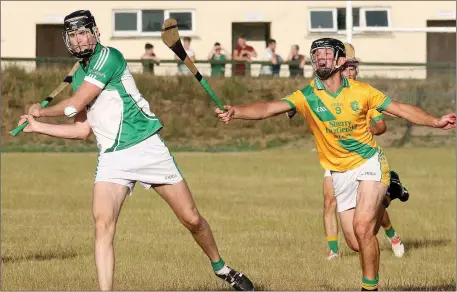  ??  ?? Cloughbawn’s Colm Kehoe about to strike as Paul O’Leary (Blackwater) attempts to hook the rival midfielder.