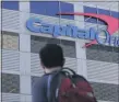  ?? JEFF CHIU - THE ASSOCIATED PRESS FILE PHOTO ?? In this July 16, 2019, file photo, a man walks across the street from a Capital One location in San Francisco.