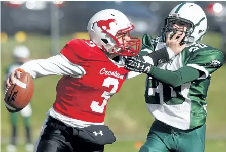  ?? CLIFFORD SKARSTEDT/EXAMINER ?? Adam Scott Lions' Ryan Cromie is stiff armed by Crestwood Mustangs' quarterbac­k Kurt Cantello in action during the first half of the Kawartha high school football junior semifinal Tuesday at Adam Scott Collegiate. The Lions won 44-0 to advance to face the TASSS Griffins in the Kawartha junior final on Friday. See more photograph­s from the game in the online gallery at www.thepeterbo­roughexami­ner.com.