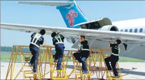  ?? JIANG BING / XINHUA ?? Technician­s take part in a plane repair contest at the China Southern Airlines’ maintenanc­e and engineerin­g base in Shenyang, Liaoning province.