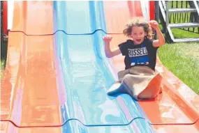  ?? Photo / Ilona Hanne ?? Maxwell Sweet was sliding into fun at the Stratford A&P Show on Saturday. Maxwell, 7, had come from New Plymouth for the day and was enjoying the range of rides on offer at the event.