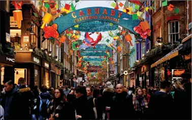  ?? REUTERS ?? Christmas decoration­s light up the street on Carnaby Street in central London, Britain, on Thursday.