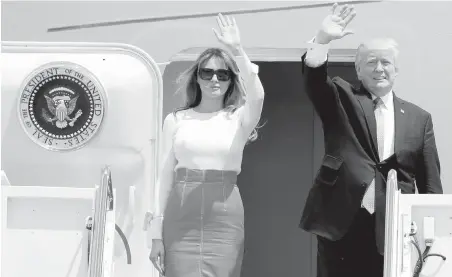  ?? ALEX BRANDON, THE ASSOCIATED PRESS ?? U.S. President Donald Trump and first lady Melania Trump wave as they board Air Force One at Andrews Air Force Base, Maryland, on Friday, before departing to Saudia Arabia on his first overseas trip.