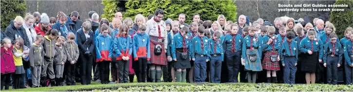  ??  ?? Scouts and Girl Guides assemble yesterday close to crash scene