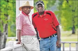  ?? Chris Thelen For The Times ?? JARIAH BEARD, left, and Buck Moore, shown at Augusta Municipal Golf Course, regularly worked the Masters before pros began using their own caddies.