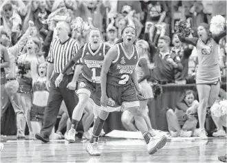  ?? LM Otero / Associated Press ?? Mississipp­i State’s Morgan William (2) was on top of the college basketball world Friday night when she hit a shot at the buzzer in overtime to end Connecticu­t’s record 111-game winning streak.